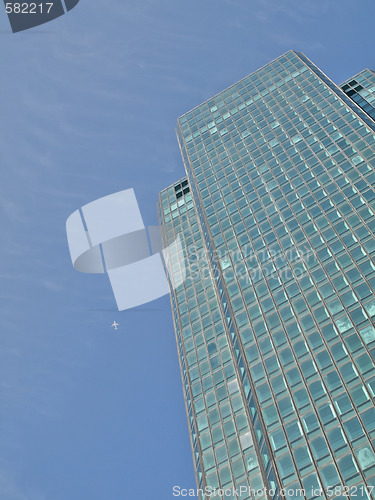 Image of Green skyscraper and jet plane