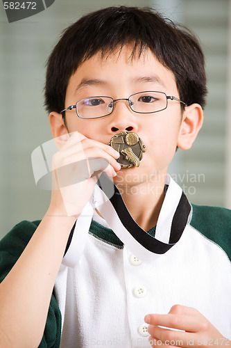 Image of Winning boy kissing medal