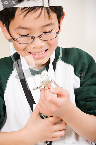 Image of Winning boy with his medal and trophy