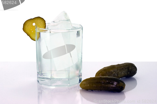 Image of Vodka with ice in glass and salt cucumbers