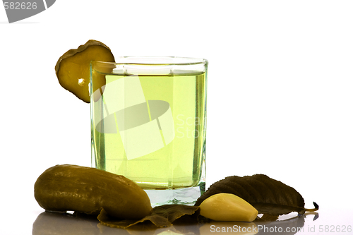 Image of Cucumber brine in the glass and salt vegetables