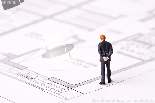 Image of businessman examining a blueprint