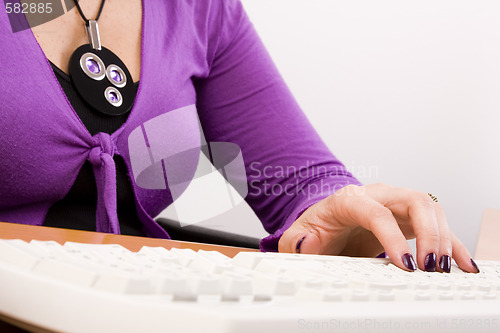 Image of hand typing in a keyboard