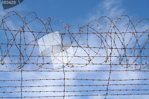 Image of restrictions barbed wire blue sky