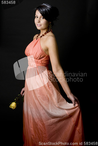 Image of shapely pretty young woman smiling pretty dress with rose
