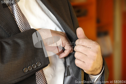 Image of Businessman hand in inner pocket