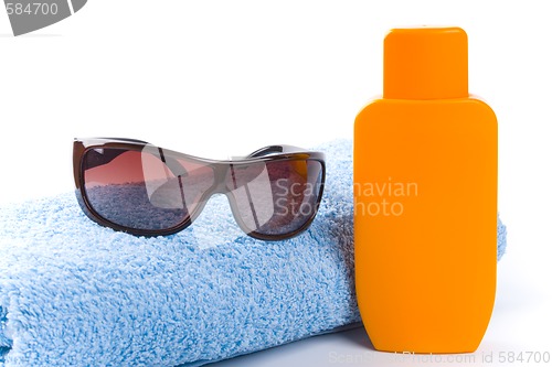 Image of towel, sunglasses and lotion