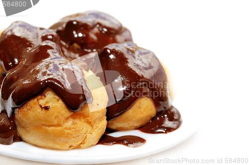 Image of Fresh profiteroles with hot chocolate sauce.