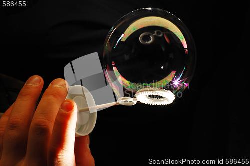 Image of child's hand and soap bubble