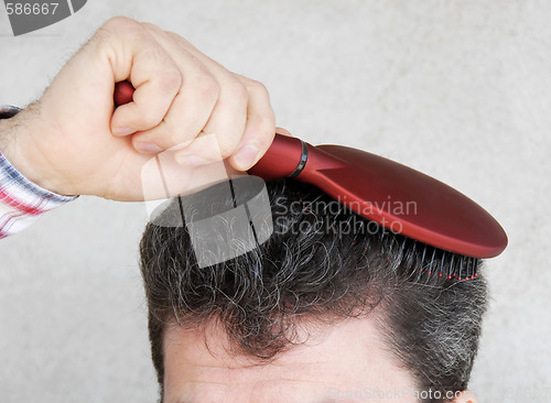 Image of Man brushing hair