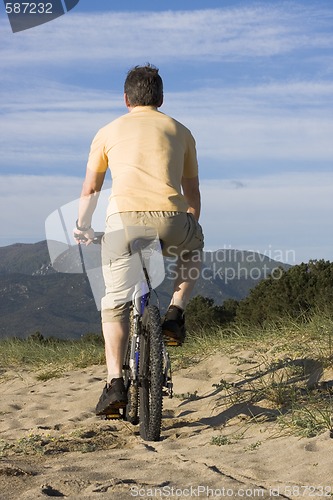 Image of Man riding bicycle