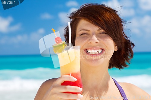 Image of happy woman with colorful cocktail