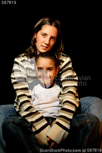 Image of aunt and nephews over black background