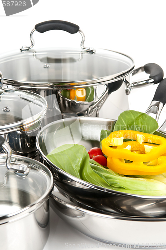 Image of Stainless steel pots and pans with vegetables