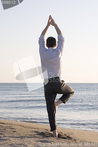 Image of Businessman doing yoga