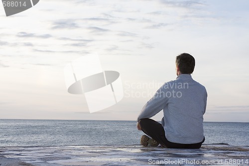Image of Man meditating at the sea
