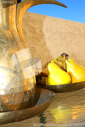 Image of Brass Decanter And Fruits On A Table