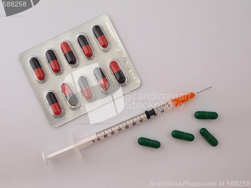 Image of Hypodermic syringe and drugs.