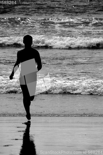 Image of SILHOUETTE RUNNING AT THE BEACH