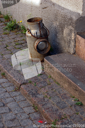 Image of Milk can at doorstep