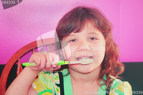 Image of Young girl brushing her teeth