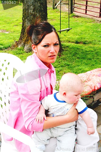 Image of Young mother feeding baby