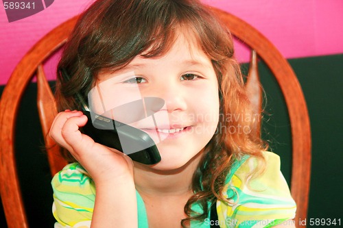 Image of Young girl talking on telephone