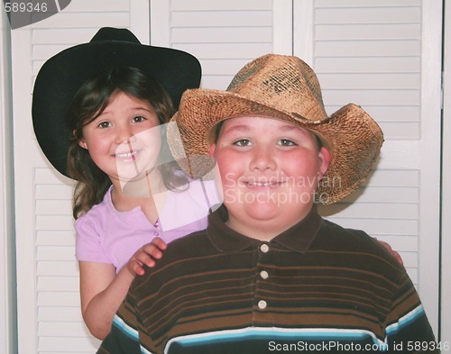 Image of Brother and sister with cowboy hats