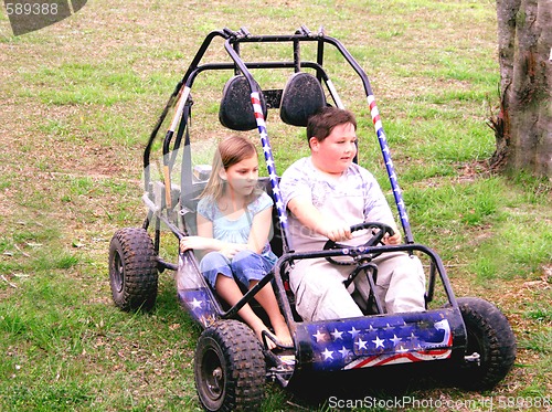 Image of Young boy and girl on go cart