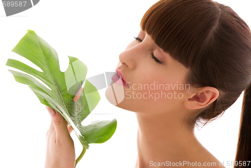 Image of woman with green leaf