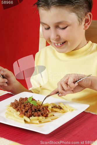 Image of Child eating pasta