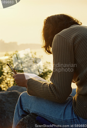 Image of Female painter in sunrise