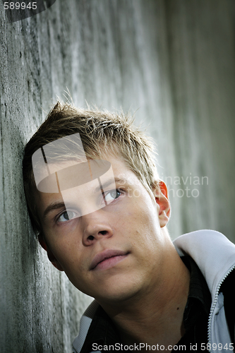 Image of Man leaning against a wall