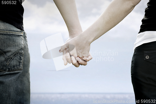 Image of A couple holds hands i