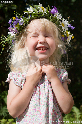 Image of laughing little girl in flowers wreath