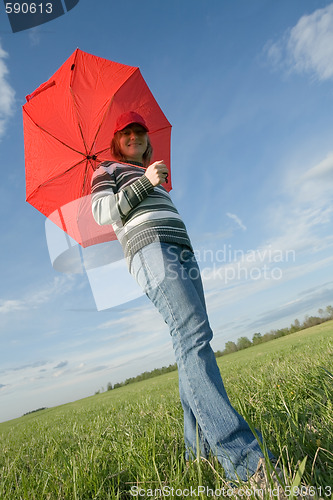 Image of woman under red umbrella