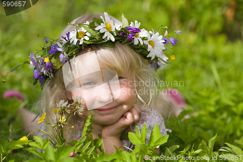 Image of happy little girl on green meadow