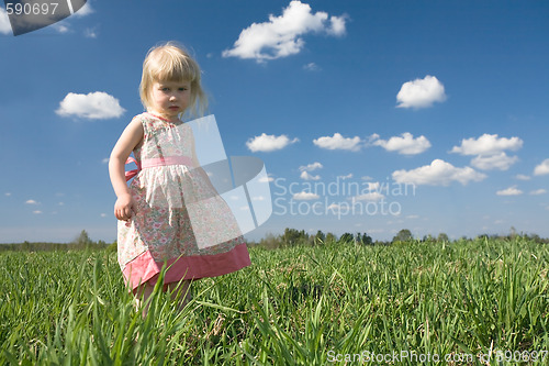 Image of little girl on green meadow