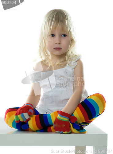 Image of little girl sits on white chair