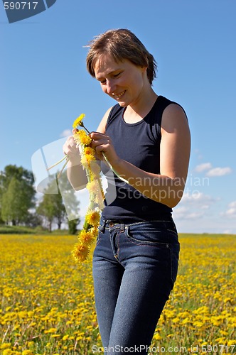 Image of woman twining a dandelion wreath