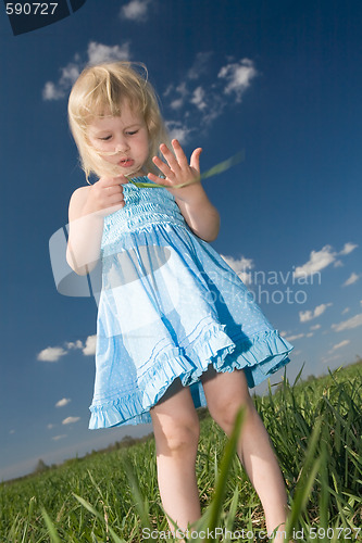 Image of little girl with grass in hands
