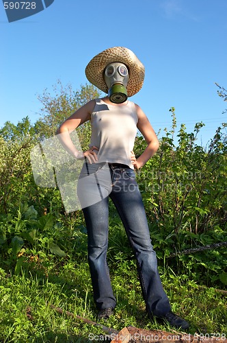 Image of woman in gas-mask at garden work