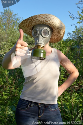 Image of woman in gas-mask at garden work