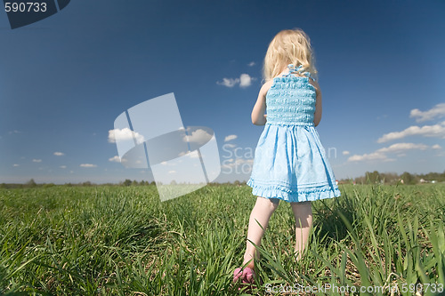 Image of little girl on wide green meadow