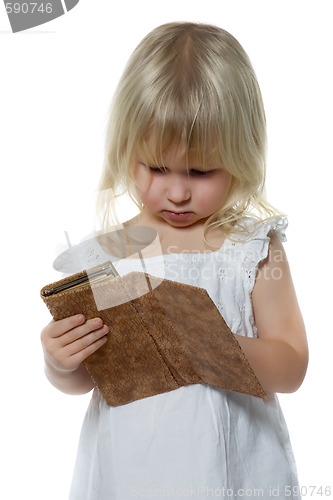 Image of Little girl looks in purse