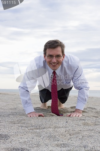 Image of Businessman doing push-ups