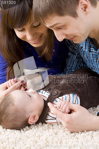 Image of Happy young parents with their baby