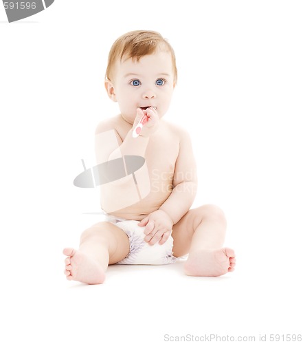 Image of baby boy in diaper with toothbrush