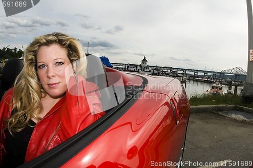 Image of woman red sports car