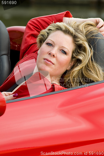 Image of woman red sports car